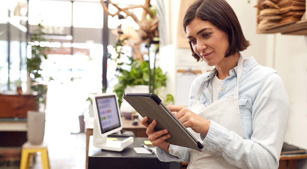 Shop owner on laptop